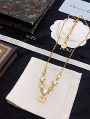 CD 26S CD LOGO CRYSTAL STATION NECKLACE IN GOLD TONE METAL WITH WHITE CRYSTAL 631006