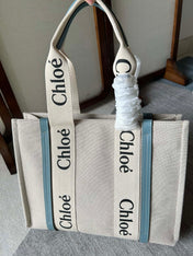 LAGRE WOODY TOTE BAG 45 IN BEIGE LINEN CANVAS BLACK WEBBING LOGO EMBROIDER BLUE CALFSKIN