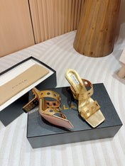 ALAIA TWO-STRAPS HIGH HEEL SANDALS IN GOLDEN PATENT LAMBSKIN