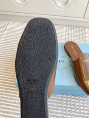 MULES IN BROWN GLOSSY SHEEPSKIN GOLD LETTERING LOGO