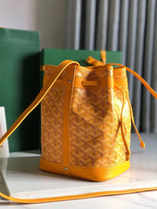 PETIT FLOT BUCKET BAG 22 IN YELLOW GOYARDINE CANVAS AND LAMBSKIN TRIM
