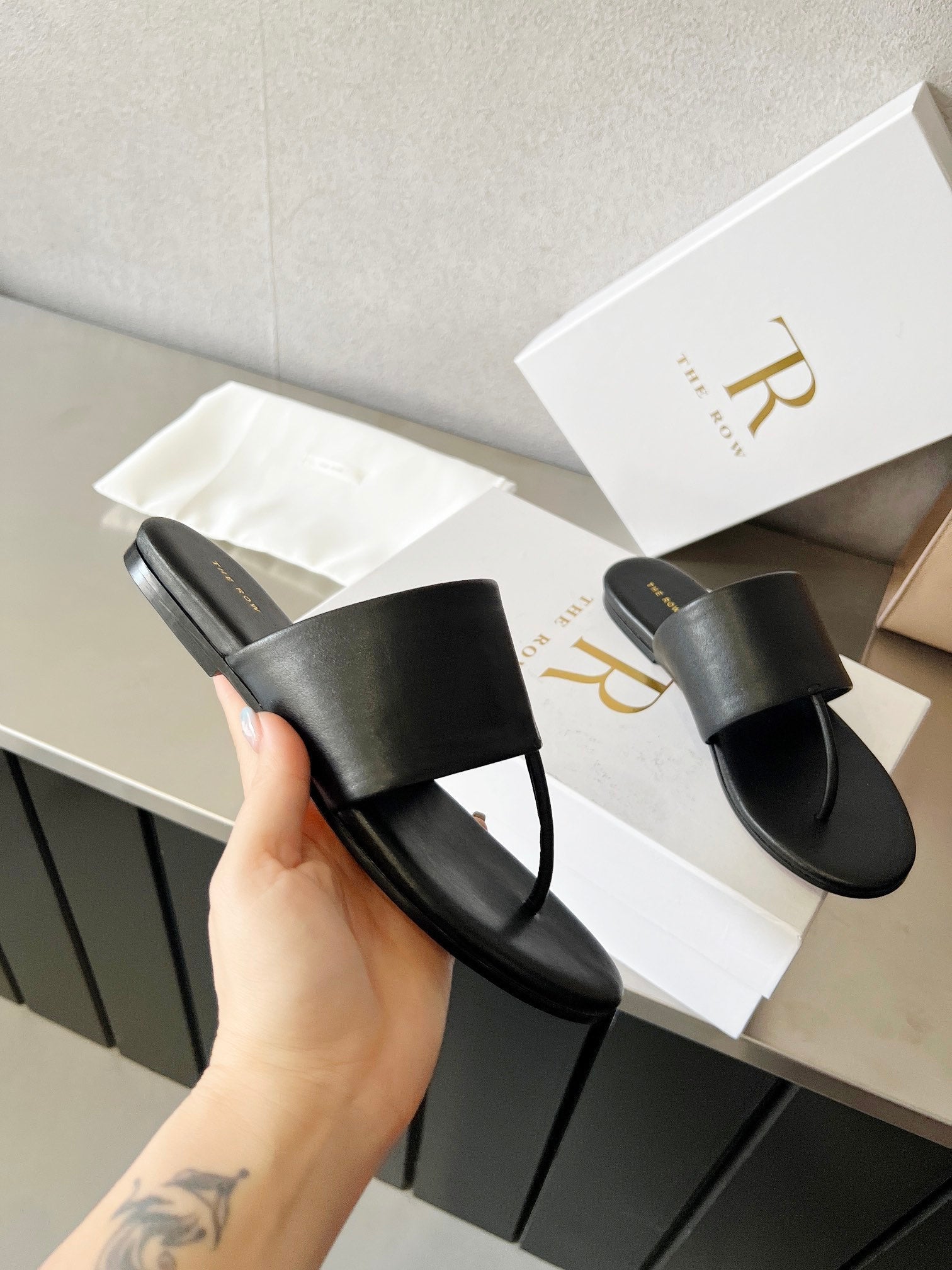 THE ROW 26S FLAT THONG SANDALS IN BLACK CALFSKIN