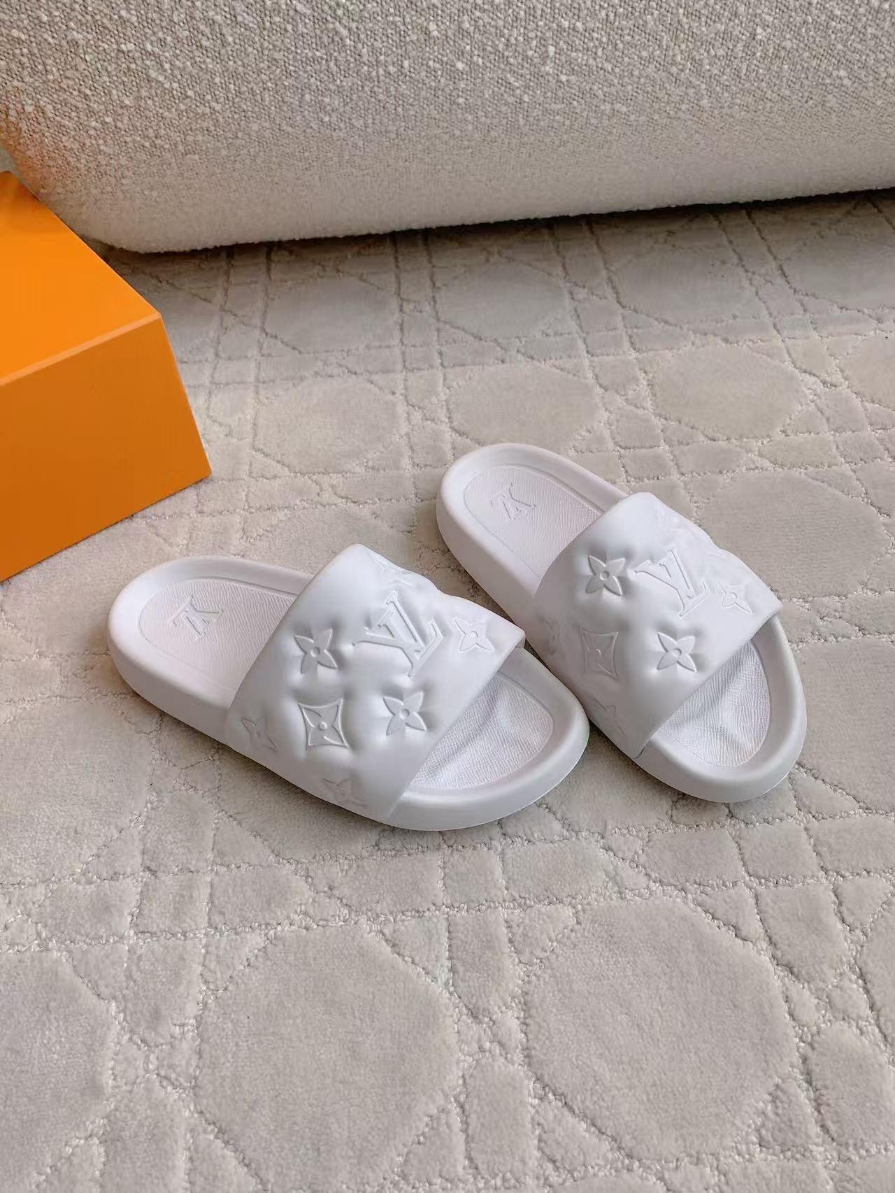 LV EMBOSSED POOL PILLOW SANDALS IN WHITE RUBBER