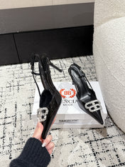 POINTED HIGH SLINGBACK IN BLACK PATENT CALFSKIN WITH CRYSTAL BUCKLE