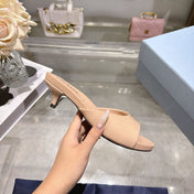 PRADA 26S LOGO EMBOSSED KITTEN HEEL MULES IN NUDE BEIGE PATENT CALFSKIN