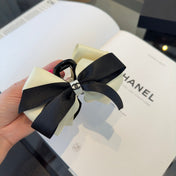 CHANEL 26S BOW HAIR CLIP IN BLACK AND WHITE SATIN 503131