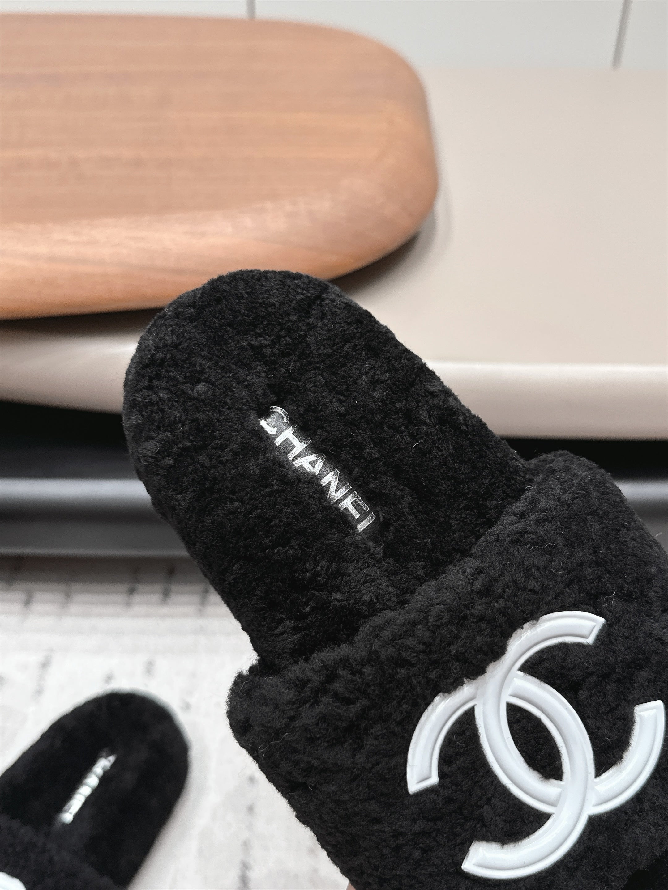 CHANEL 26S SLIDE MULES IN BLACK SHEARLING AND WHITE CC LOGO
