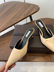 ALAIA 26S HEELED MULES 50 MM IN WARM BEIGE FABRIC