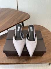 ALAIA 26S HEELED MULES 50 MM IN LAVENDER GREY FABRIC