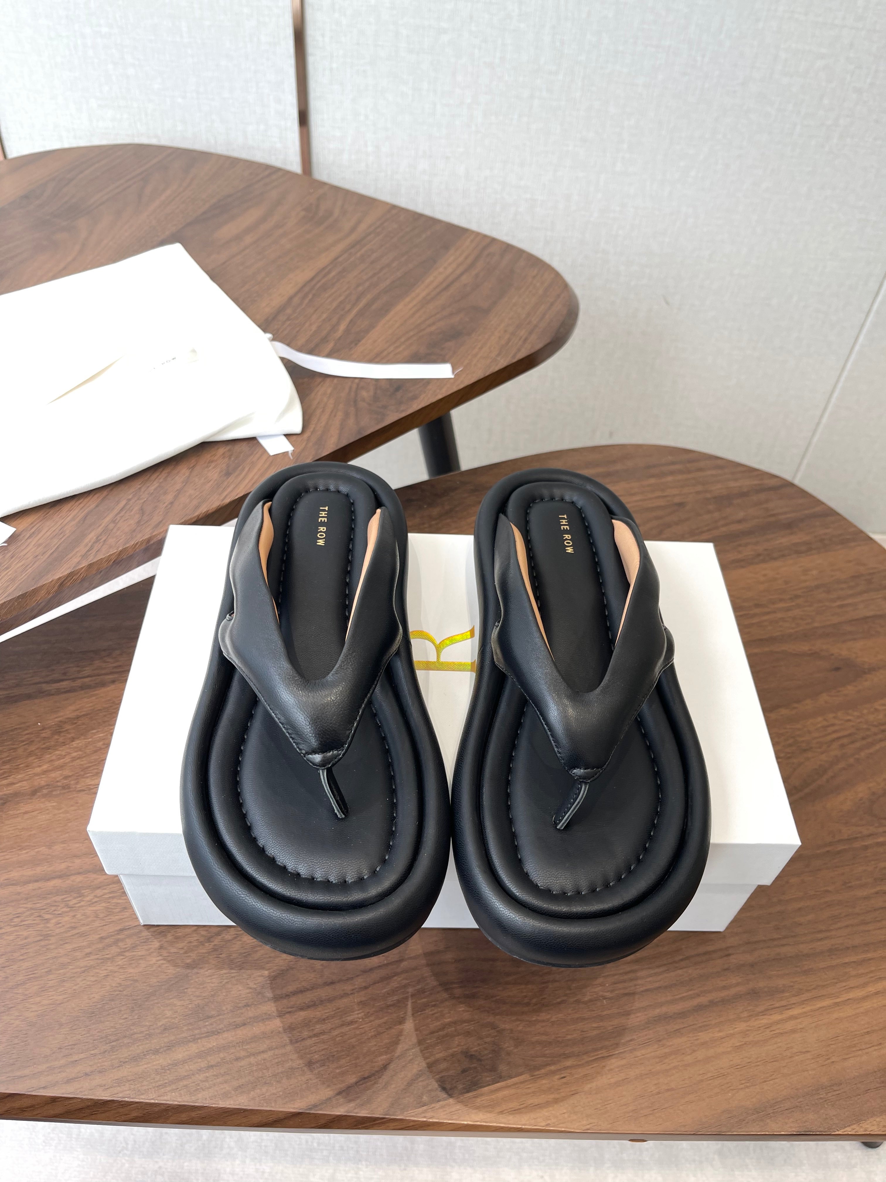 THE ROW 26S PUFFED THONG SANDALS IN BLACK CALFSKIN