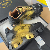 PRADA 26S CLOUDBUST THUNDER SNEAKERS 60MM IN BLACK AND GOLD MESH FABRIC AND TPU