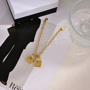 MIUMIU 26S DOUBLE PADLOCK CHARM CHAIN BRACELET IN GOLD TONE METAL 619260