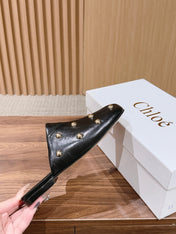 CHLOE 26S STUDDED FLAT MULES IN BLACK CALFSKIN