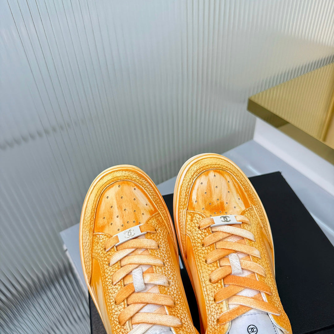 CHANEL 26S LOW-TOP SNEAKERS IN GOLDEN ORANGE CALFSKIN