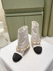 CHANEL 25S CALF-LENGTH BOOTS 45MM IN WHITE AND BLACK CALFSKIN GOLD HARDWARE