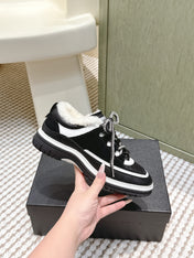 CHANEL 25S THICK-SOLE SNEAKERS IN BLACK AND WHITE CALFSKIN WITH FUR LINING