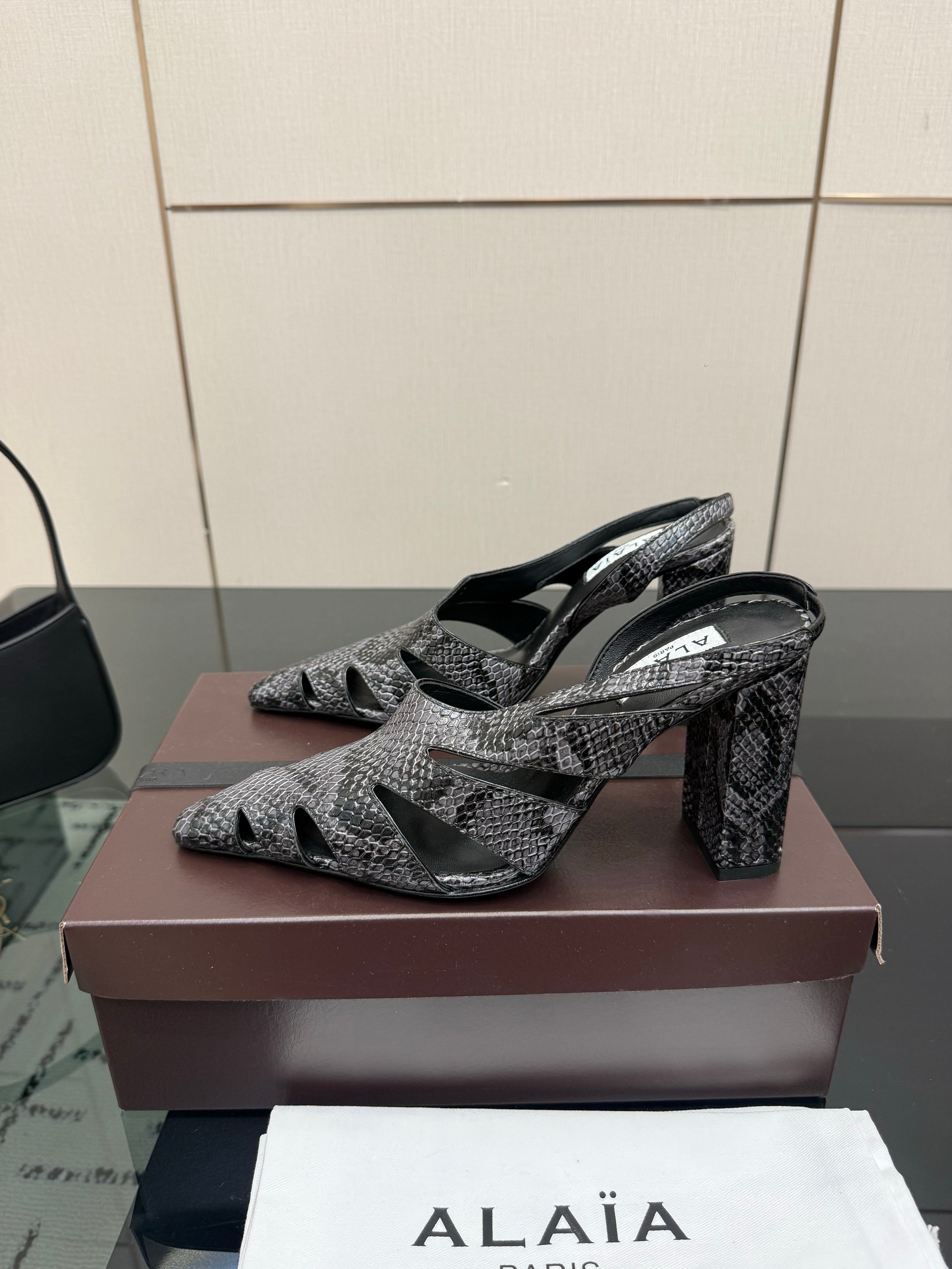 ALAIA 26S HEELED SLINGBACKS IN BLACK PYTHON-EMBOSSED LEATHER