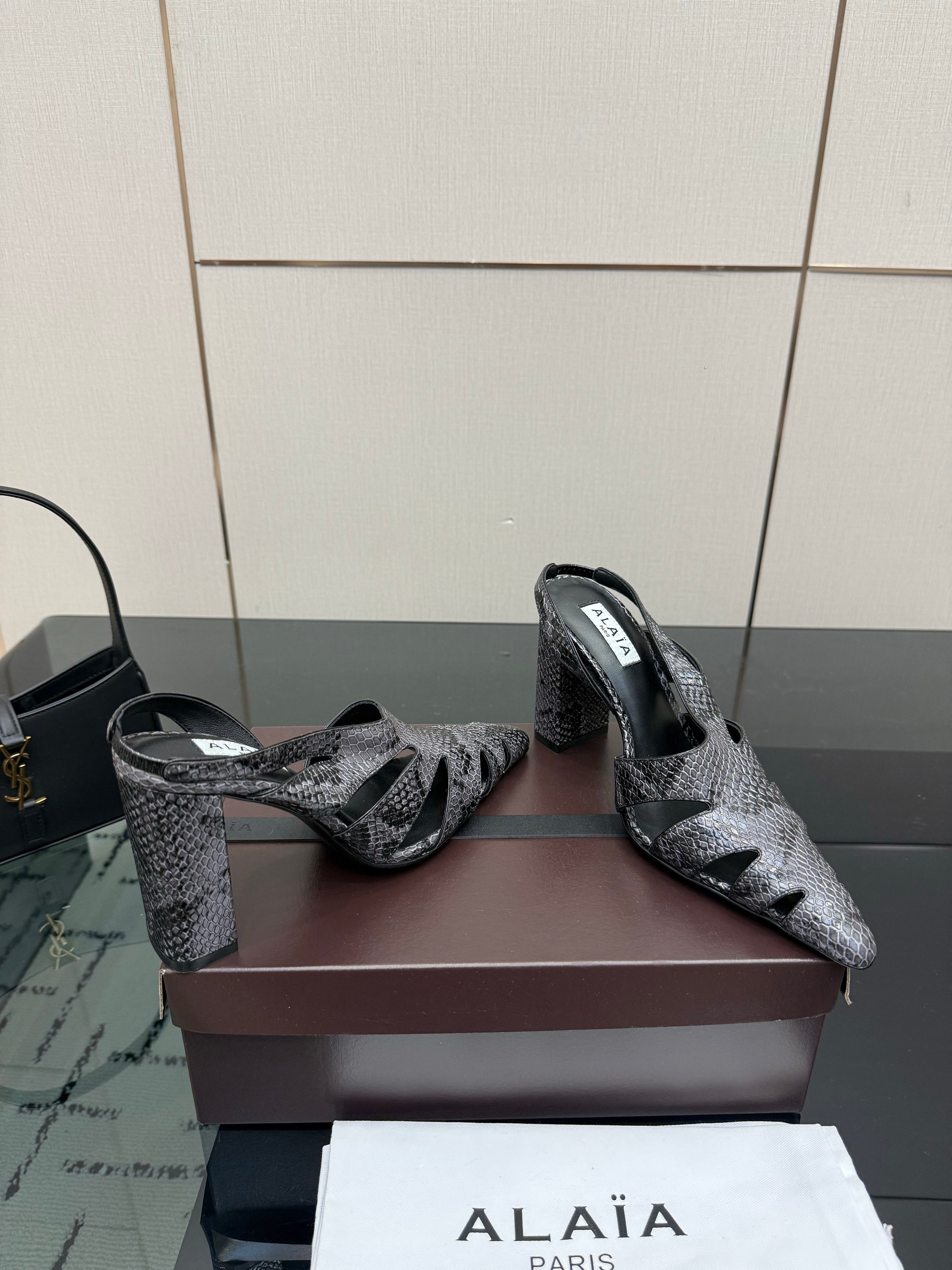 ALAIA 26S HEELED SLINGBACKS IN BLACK PYTHON-EMBOSSED LEATHER