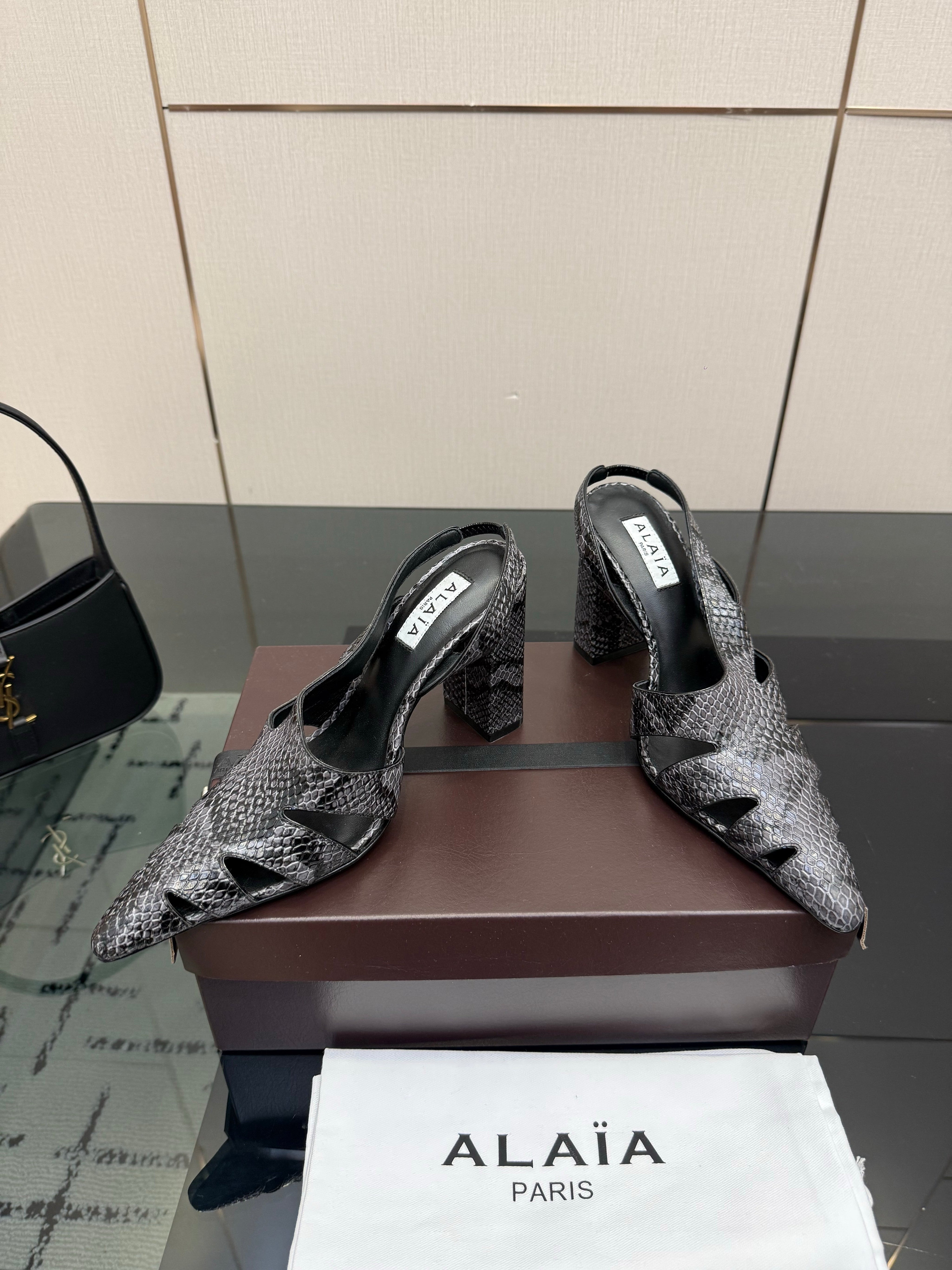 ALAIA 26S HEELED SLINGBACKS IN BLACK PYTHON-EMBOSSED LEATHER