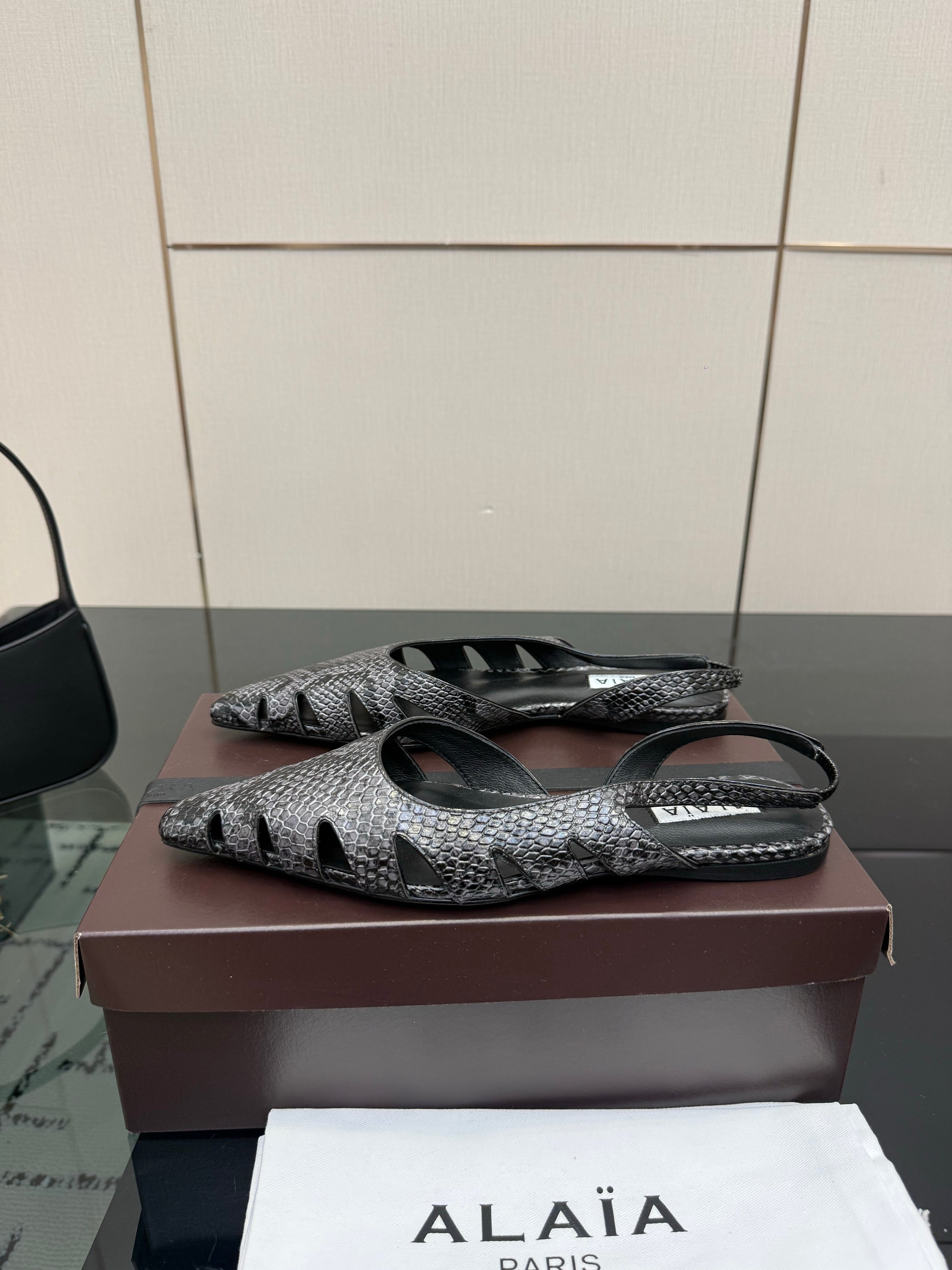 ALAIA 26S CUT-OUT SLINGBACK FLATS IN BLACK PYTHON-EMBOSSED LEATHER