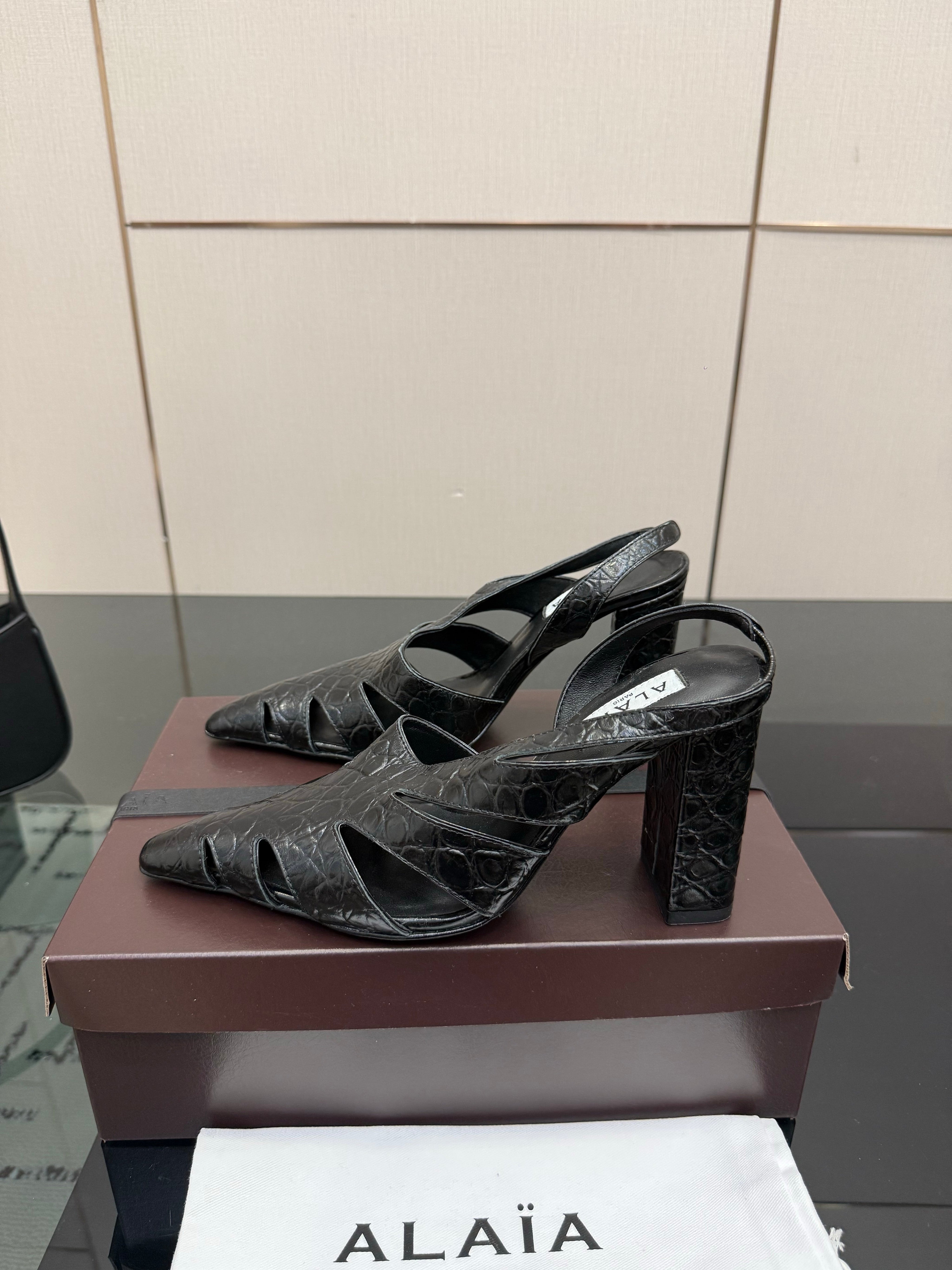 ALAIA 26S HEELED SLINGBACKS IN BLACK CROC-EMBOSSED LEATHER