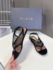 ALAIA 26S FLAT MESH THONG SANDALS IN BLACK PATENT CALFSKIN