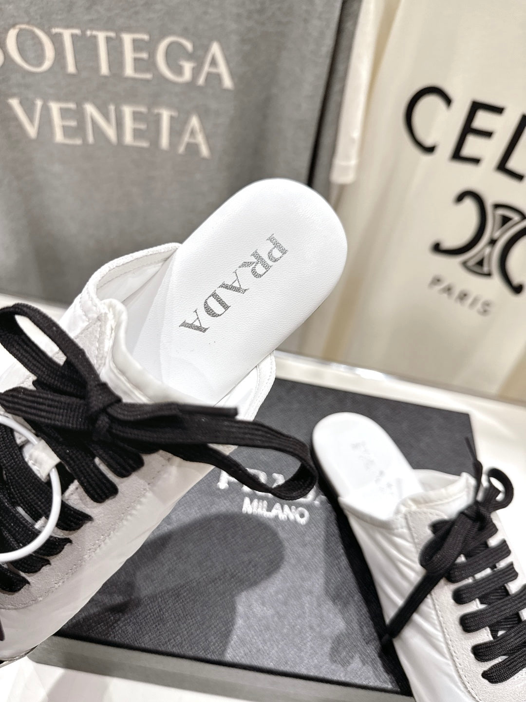 PRADA 25S MULES IN WHITE WITH METAL TOECAP