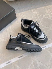 CHANEL 25S TRAINERS 40MM IN BLACK AND WHITE CALFSKIN AND SUEDE