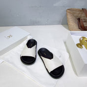 THE ROW 26S CROSS STRAP SLIDES IN IVORY WHITE CALFSKIN WITH BLACK FOOTBED