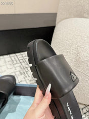 PRADA 25S PADDED SLIDES IN BLACK CALFSKIN WITH LOGO