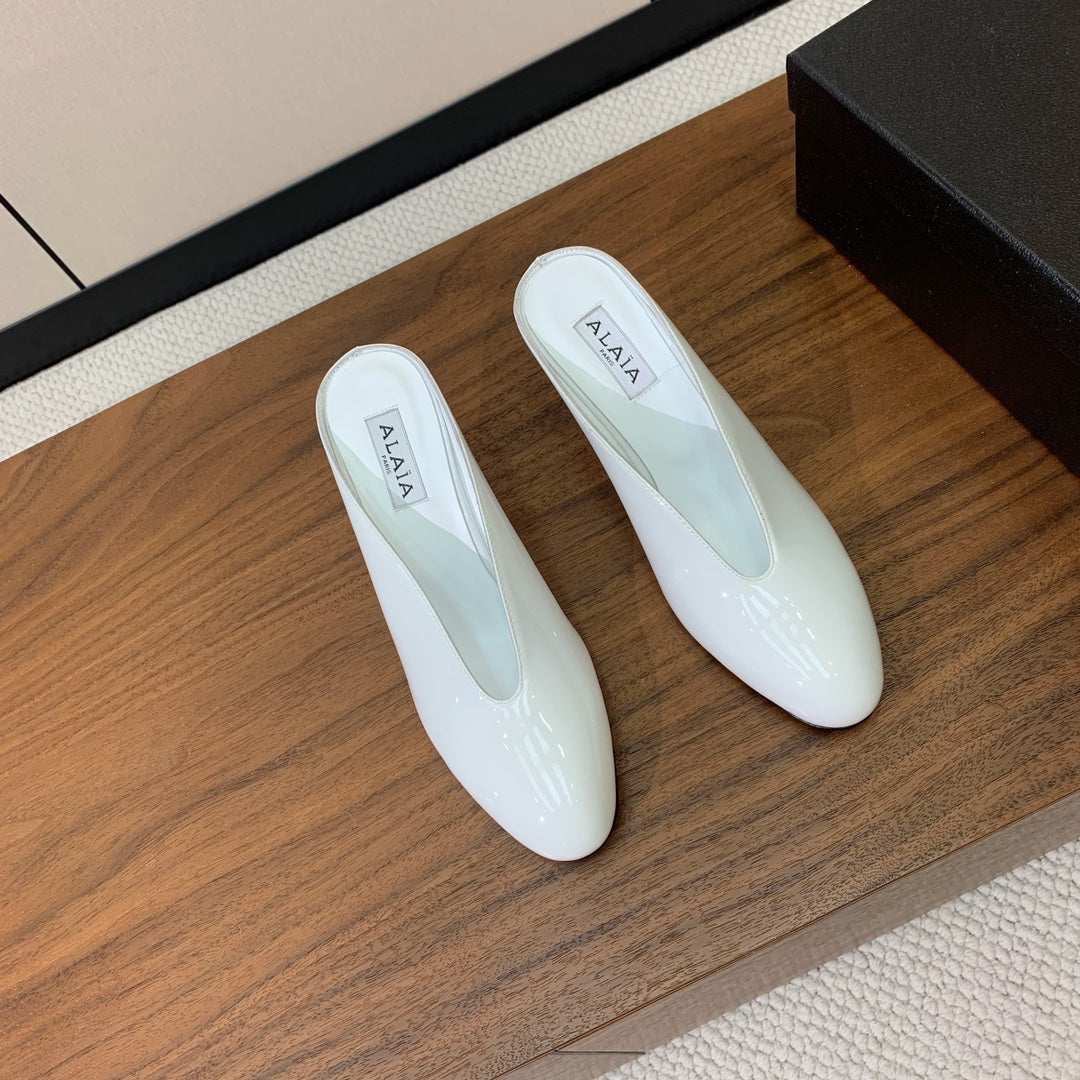 ALAIA 26S WEDGE MULES 70 MM IN WHITE GLOSSY CALFSKIN