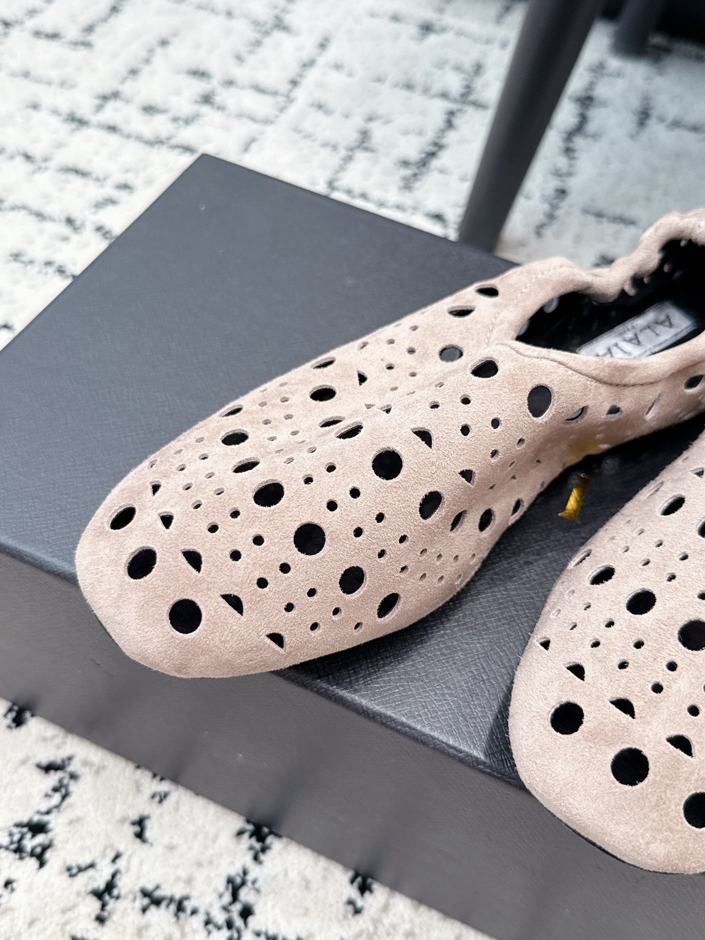 ALAIA 26S FLAT SLIP-ONS IN NUDE PINK SUEDE WITH OPENWORK PATTERN