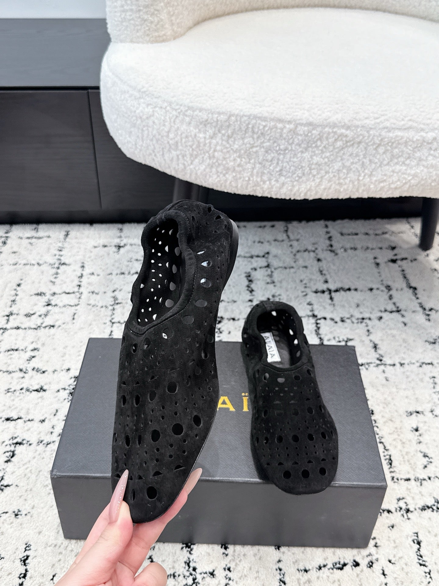 ALAIA 26S FLAT SLIP-ONS IN BLACK SUEDE WITH OPENWORK PATTERN