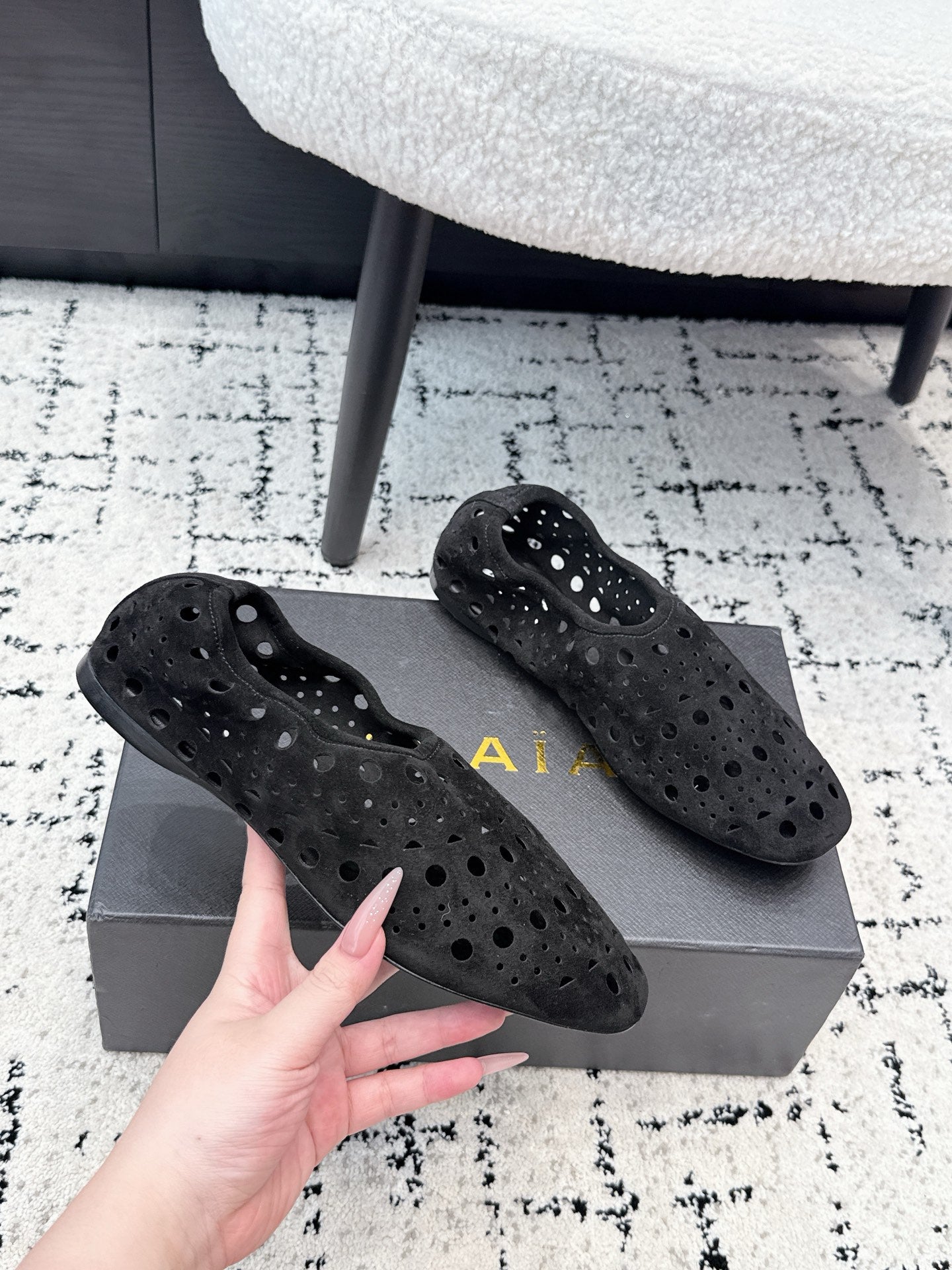 ALAIA 26S FLAT SLIP-ONS IN BLACK SUEDE WITH OPENWORK PATTERN