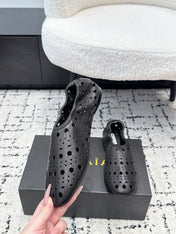ALAIA 26S FLAT SLIP-ONS IN BLACK CALFSKIN WITH OPENWORK PATTERN