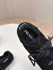 PRADA 26S LACE UP MINIMAL SNEAKERS IN BLACK CANVAS
