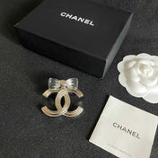 CHANEL 26S DOUBLE C LOGO BOW DETAIL OPENWORK BROOCH IN GOLD METAL 629193