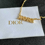 CD 26S PAVE LOGO LETTER NECKLACE IN GOLD TONE METAL 631806
