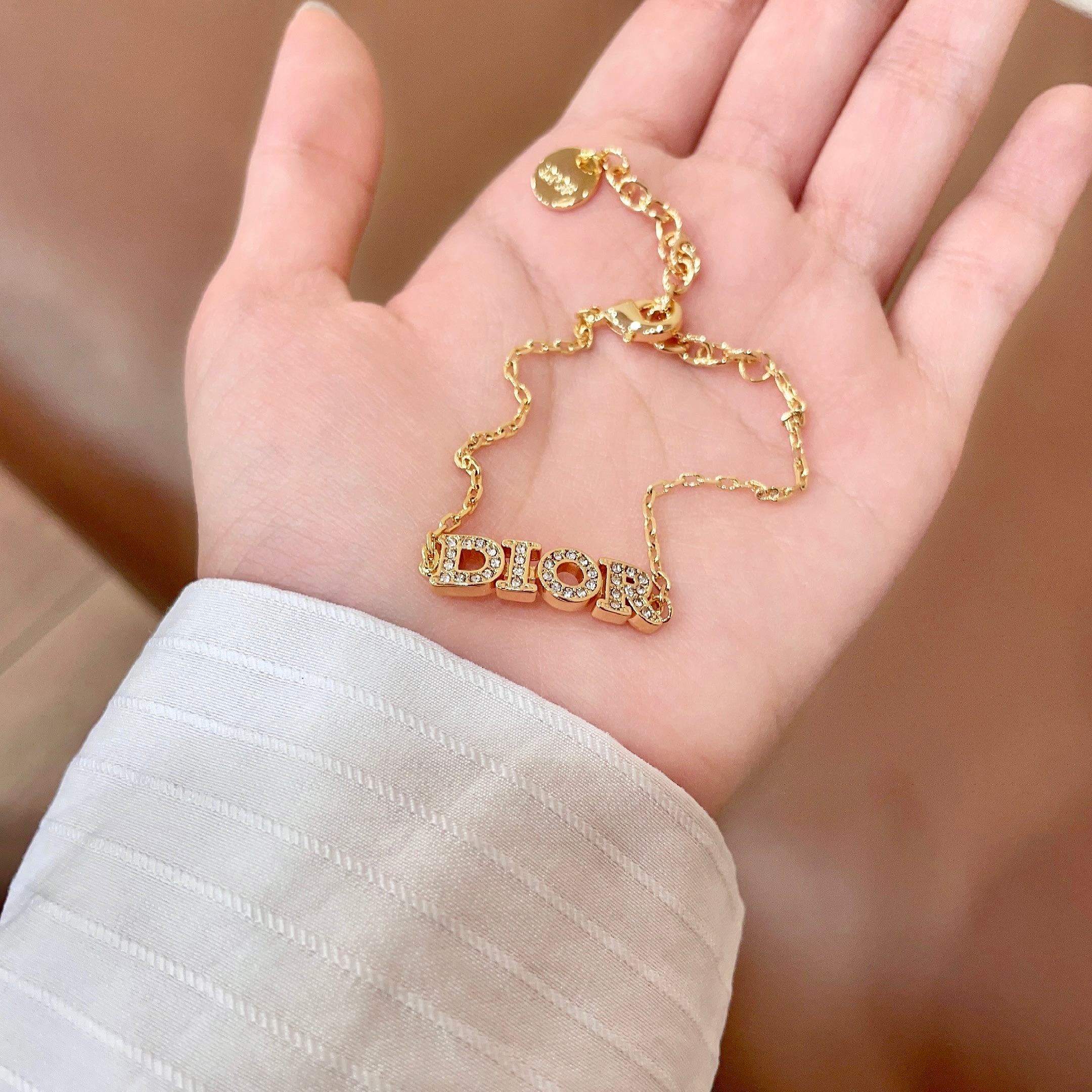 CD 26S PAVE LOGO LETTER BRACELET IN GOLD TONE METAL 631808