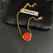 MIUMIU 26S LOGO ROUND BRACELET IN RED ENAMEL AND GOLD TONE METAL 631810