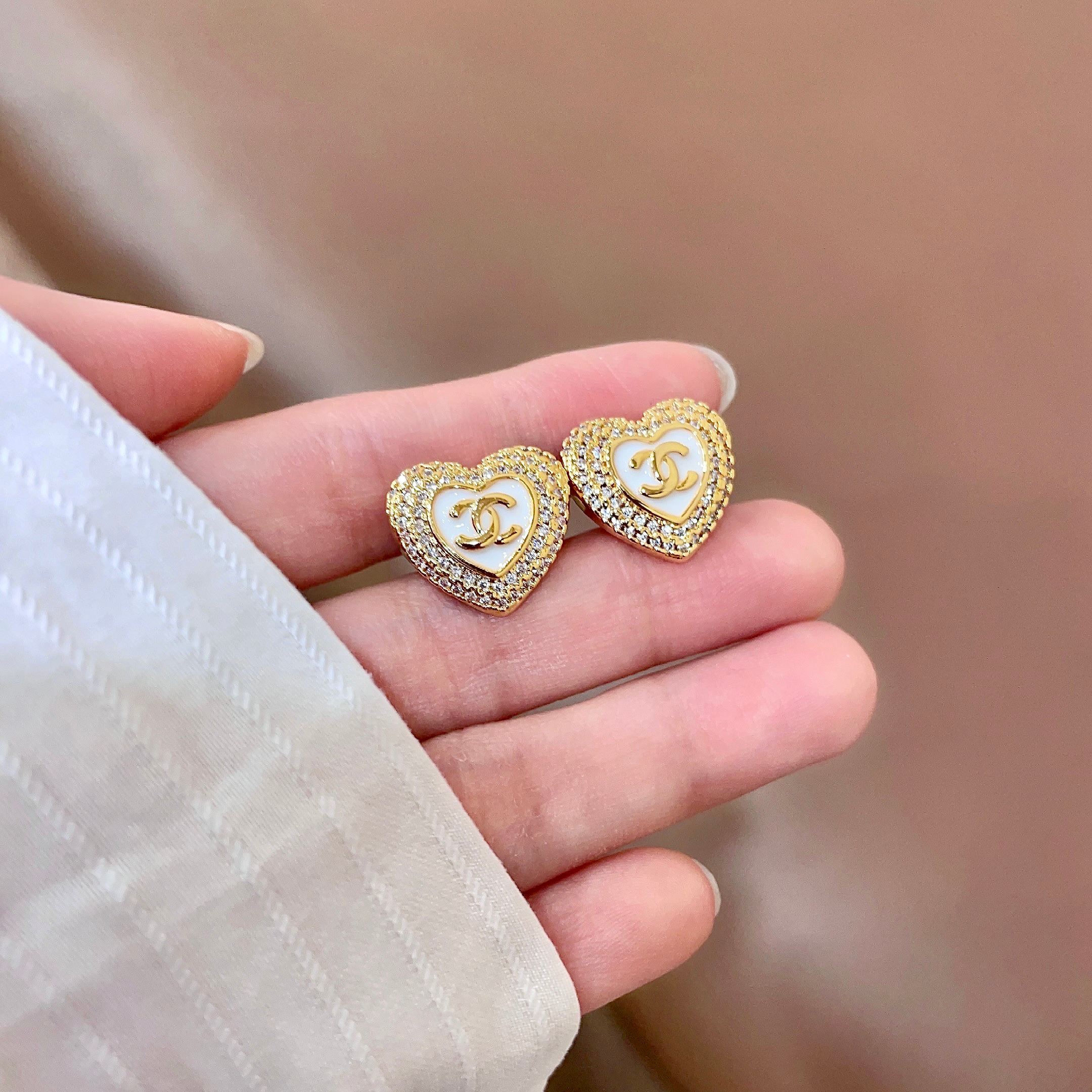 CHANEL 26S DOUBLE C LOGO PAVE HEART STUD EARRINGS WITH WHITE ENAMEL IN GOLD METAL 631815