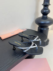 MIUMIU 26S LOW-HEEL THONG SANDALS IN BLACK AND SILVER CALFSKIN