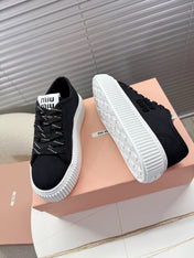 MIUMIU 26S PLATFORM SNEAKERS IN BLACK CANVAS