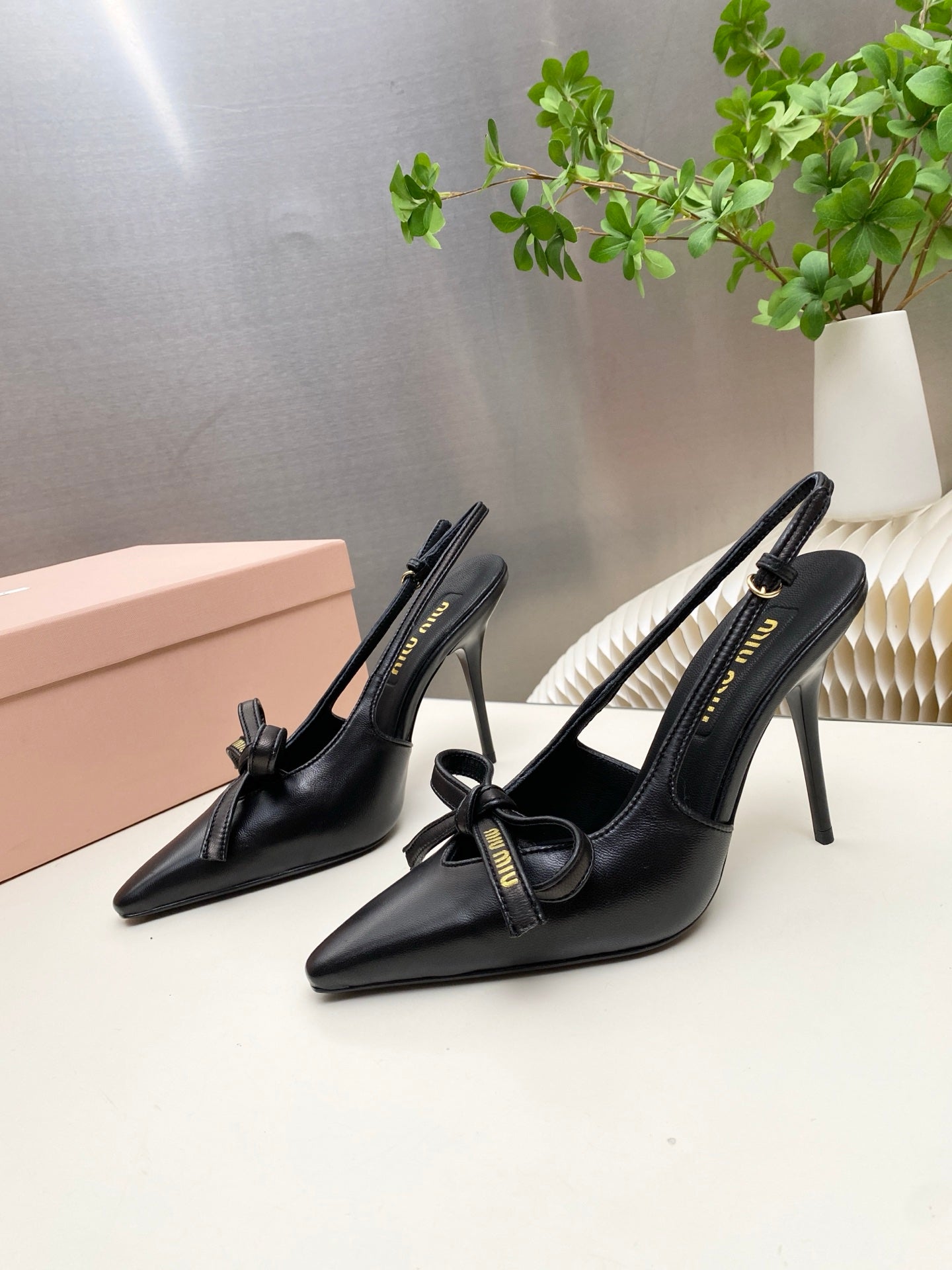 MIUMIU 26S SLINGBACK PUMPS 105MM IN BLACK CALFSKIN WITH BOW