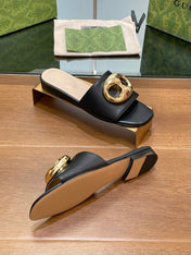 FLAT MULE IN BLACK CALFSKIN WITH GOLD HARDWARE