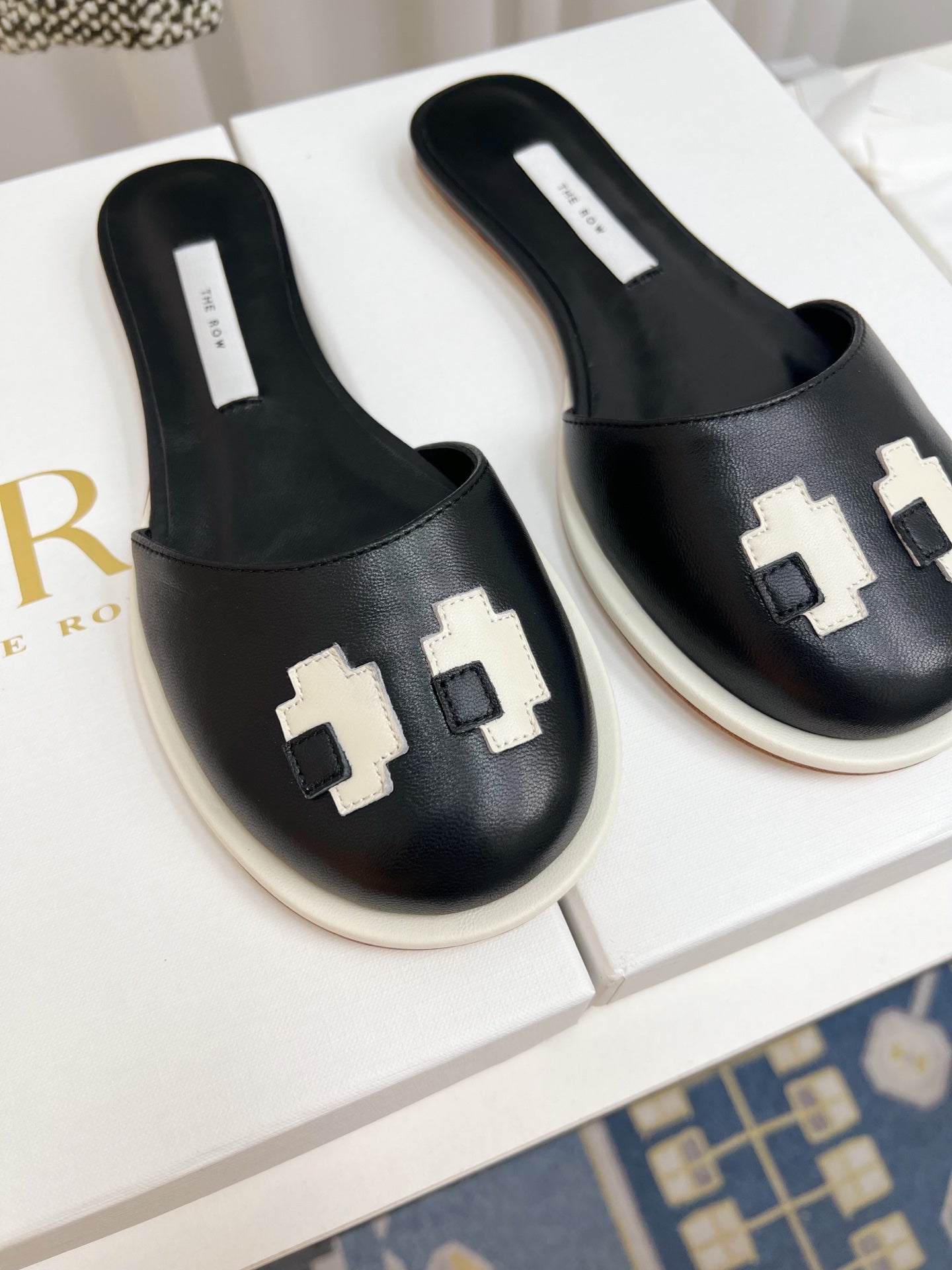 THE ROW 26S PIXEL APPLIQUE MULES IN BLACK CALFSKIN