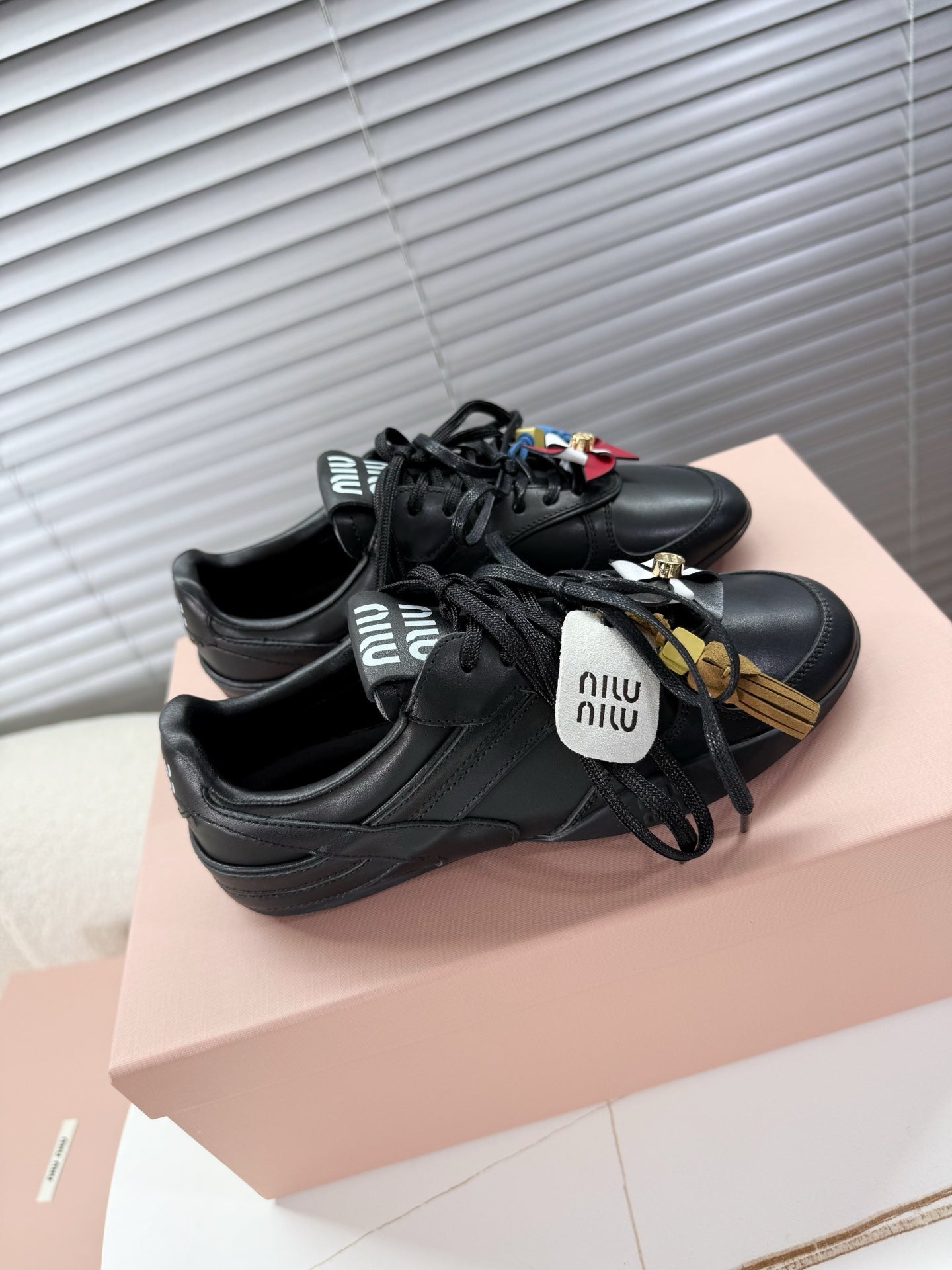 MIUMIU 26S GYMNASIUM SNEAKER IN BLACK CALFSKIN WITH GOLD BUCKLED STRAP