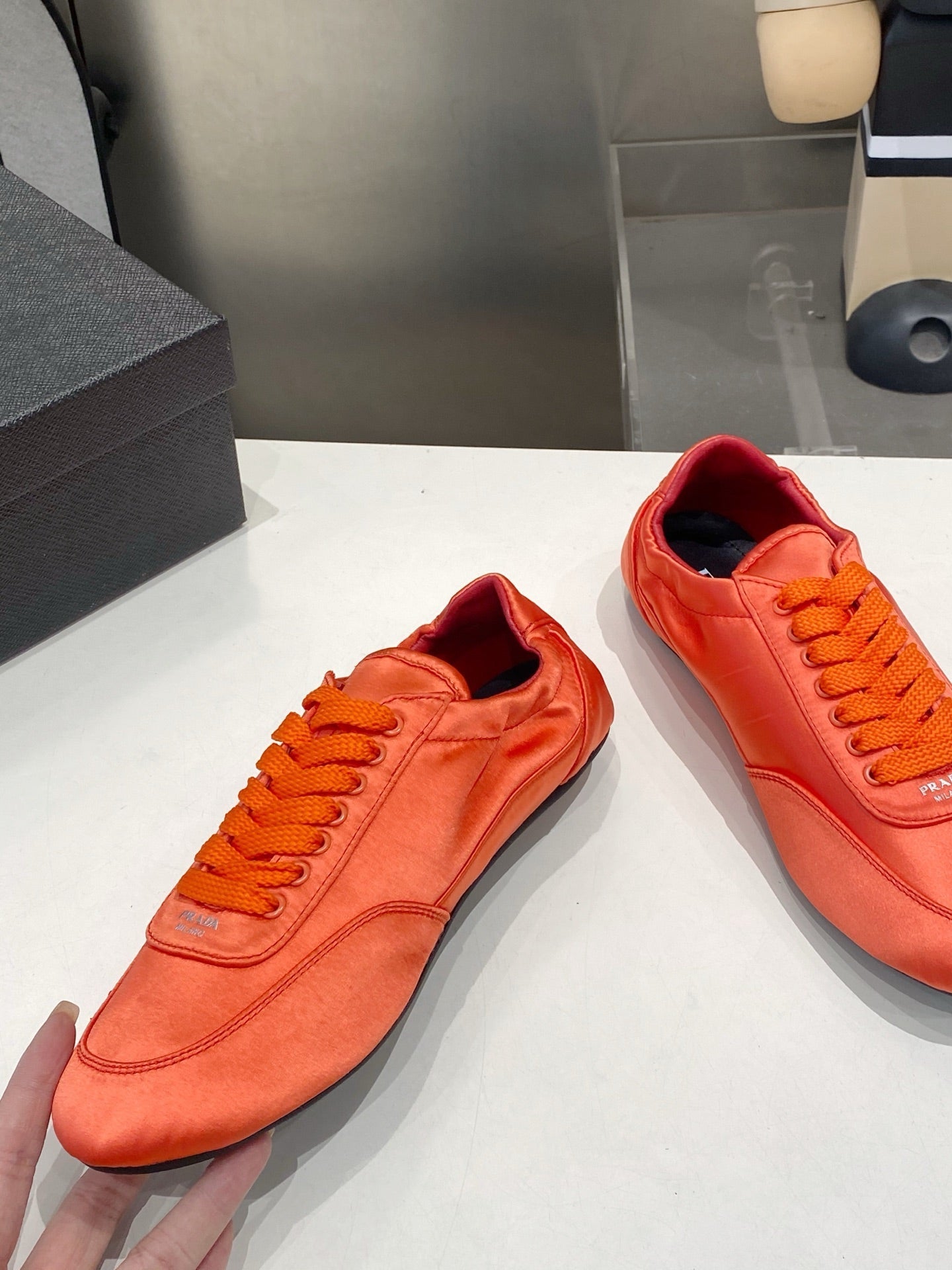 PRADA 26S SNEAKERS IN BURNT ORANGE SATIN