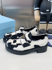 PRADA 26S LOAFERS IN WHITE AND BLACK COW PRINT PONY HAIR