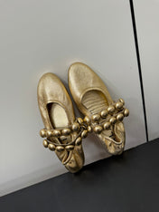 ALAIA SPHERE BALLET FLATS IN GOLDEN LAMBSKIN